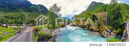 Panoramic view of a beautiful mountain river. Cascade mountain stream with rapids. Briksdal glacier hike Briksdalsbreen mountain lodge Panoramic view of a beautiful mountain river. Cascade mountain stream with rapids. Briksdal glacier hike Briksdalsbreen mountain lodge 134633010