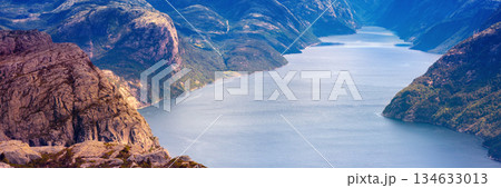 View of the beautiful Lysefjord on a cloudy day. The rocky shore of the majestic Lysefjord. Beautiful wildlife of Norway. View from Preikestolen View of the beautiful Lysefjord on a cloudy day. The rocky shore of the majestic Lysefjord. Beautiful wildlife of Norway. View from Preikestolen 134633013