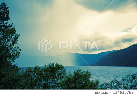 View of the fjord with a dramatic stormy sky. Rain fell on half the fjord. Beautiful wildlife of Norway 134633768