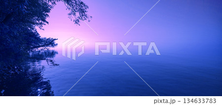 Serene lake during sunrise. Magic sunrise over the lake. Misty early morning, rural landscape. Horizontal banner 134633783