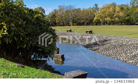 青空と公園を流れる小川とベンチと広場 青空と公園を流れる小川とベンチと広場 134633968