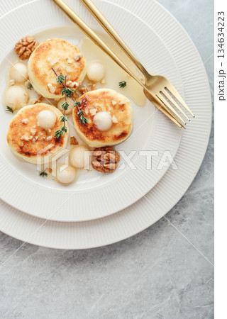 cottage cheese pancakes, syrniki, curd fritters with pear balls, walnut and honey cottage cheese pancakes, syrniki, curd fritters with pear balls, walnut and honey 134634223