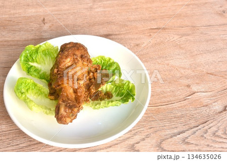 fried chicken leg herb curry and baby cos lecctue on plate 134635026