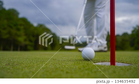 Golf ball is on a green lawn in a beautiful golf course with morning sunshine. 134635492