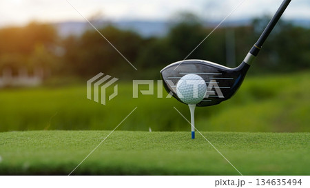 Golf clubs and golf balls on a green lawn in a beautiful golf course with morning sunshine. 134635494