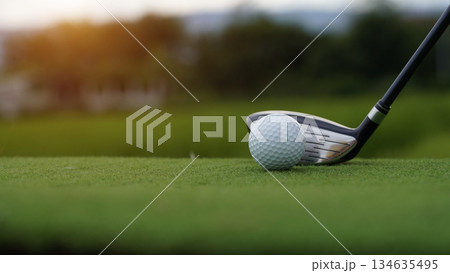 Golf clubs and golf balls on a green lawn in a beautiful golf course with morning sunshine. Golf clubs and golf balls on a green lawn in a beautiful golf course with morning sunshine. 134635495