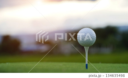 Golf clubs and golf balls on a green lawn in a beautiful golf course with morning sunshine. 134635498