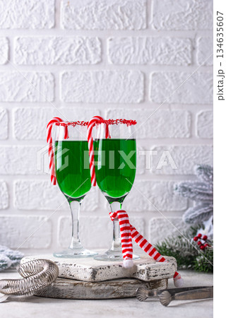 Christmas green cocktail punch with candy cane 134635607