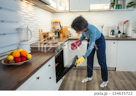 Woman baking food in modern kitchen oven 134635722