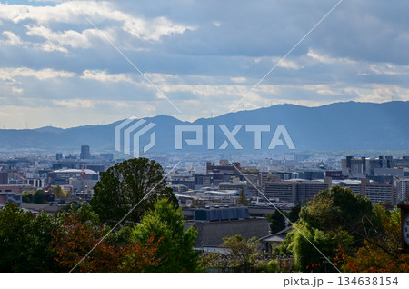 The view of Kyoto city skyline with blue sky and trees from kiyomizu-dera temple in Kyoto, Japan. Major tourist attraction in Kansai region in Japan. Travel concept. Japan cityscape. The view of Kyoto city skyline with blue sky and trees from kiyomizu-dera temple in Kyoto, Japan. Major tourist attraction in Kansai region in Japan. Travel concept. Japan cityscape. 134638154
