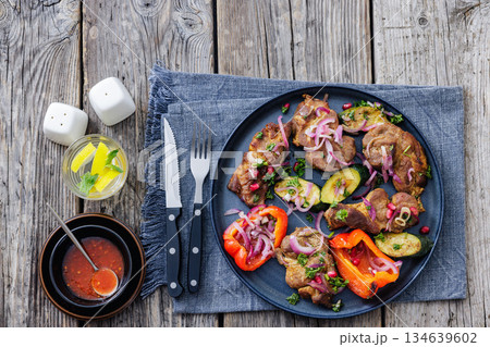 Grilled pork neck chunks with roasted veggies Grilled pork neck chunks with roasted veggies 134639602