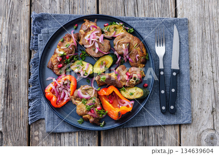 Grilled pork neck chunks with roasted veggies 134639604