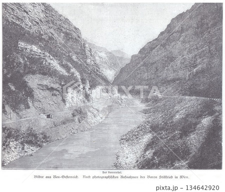 Rugged Mountain Gorge With River And Road Path In A Deep Valley 134642920