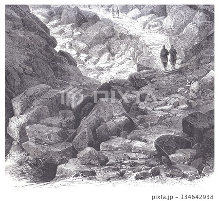 Rocky Mountain Trail With Two Hikers Walking Among Towering Boulders Landscape 134642938