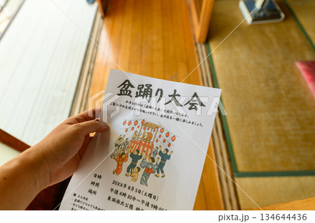 盆踊り大会の案内を持つ 134644436