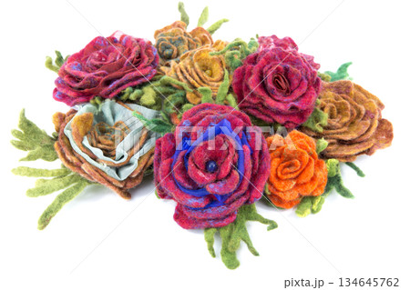 Brooch of fulled wool in the form of flowers on a white background 134645762