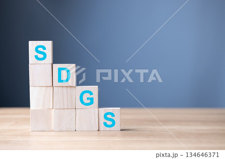 Wooden blocks display the letters SDGS, symbol Sustainable Development Goals, global progress, environmental responsibility, and commitment to long-term social and economic sustainability. Wooden blocks display the letters SDGS, symbol Sustainable Development Goals, global progress, environmental responsibility, and commitment to long-term social and economic sustainability. 134646371