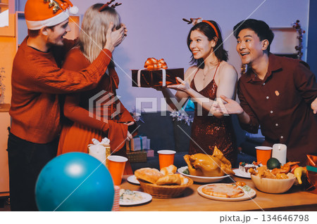 Festive Office Christmas Party with Delicious Food. A beautifully decorated office space with Christmas trees and festive lights, set up for a holiday party. 134646798