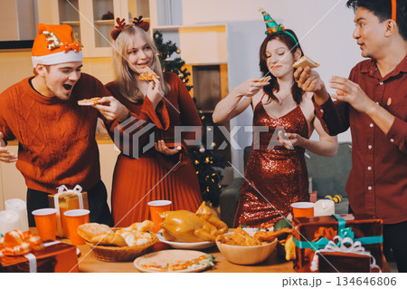 Festive Office Christmas Party with Delicious Food. A beautifully decorated office space with Christmas trees and festive lights, set up for a holiday party. 134646806