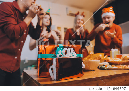 Festive Office Christmas Party with Delicious Food. A beautifully decorated office space with Christmas trees and festive lights, set up for a holiday party. 134646807