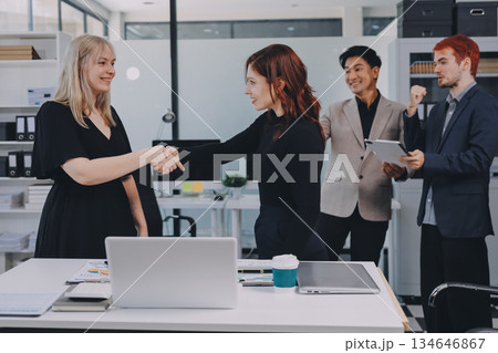 Meeting, partnership and business people shaking hands in the office for a deal, collaboration or onboarding. Diversity, professional and employees with handshake for agreement, welcome or greeting. 134646867