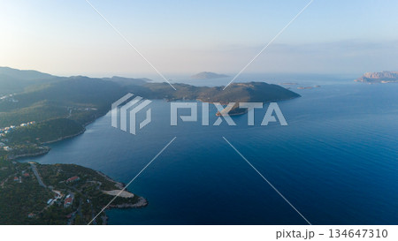 Wide aerial view of calm blue sea bay with islands and green coastline. Peaceful summer seascape with copy space. Travel, nature and vacation background.  134647310