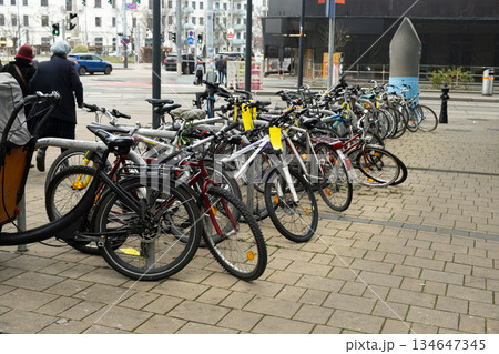 Double-decker bicycle parking with various bicycles in an urban environment Double-decker bicycle parking with various bicycles in an urban environment 134647345