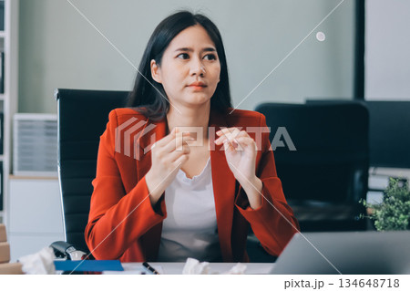 tired business woman sleepy and bored from sitting at a desk for a long time and has office syndrome tired business woman sleepy and bored from sitting at a desk for a long time and has office syndrome 134648718