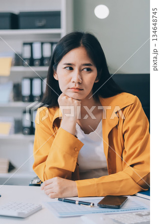 Business woman using calculator for do math finance on wooden desk in office and business working background, tax, accounting, statistics and analytic research concept. 134648745