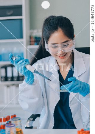Portrait, science and happy woman on laptop in lab to research chemistry, test or innovation. Microscope, scientist and face of medical doctor in goggles for microbiology, healthcare or pharma study 134648778