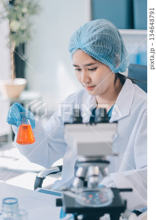 Portrait, science and happy woman on laptop in lab to research chemistry, test or innovation. Microscope, scientist and face of medical doctor in goggles for microbiology, healthcare or pharma study 134648791