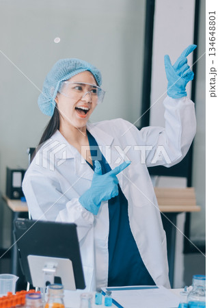 Portrait, science and happy woman on laptop in lab to research chemistry, test or innovation. Microscope, scientist and face of medical doctor in goggles for microbiology, healthcare or pharma study 134648801