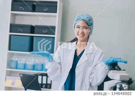 Portrait, science and happy woman on laptop in lab to research chemistry, test or innovation. Microscope, scientist and face of medical doctor in goggles for microbiology, healthcare or pharma study Portrait, science and happy woman on laptop in lab to research chemistry, test or innovation. Microscope, scientist and face of medical doctor in goggles for microbiology, healthcare or pharma study 134648802