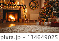 A cozy living room with a decorated Christmas tree, a warm fireplace, a fluffy carpet, and festive decorations in the evening glow. a blurred scene 134649025