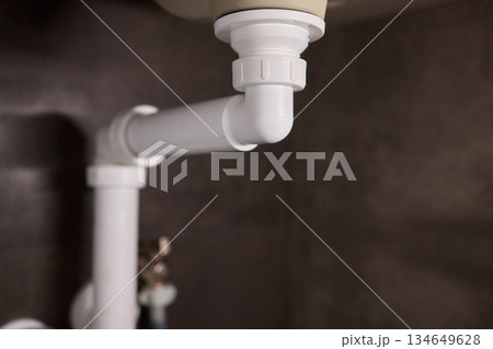 Plumbing Installation Process Under a Kitchen or Bathroom Sink Using Valves and Pipes 134649628