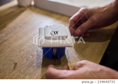 Disassembled Smart Device Displaying Its Circuit Board Alongside Various Components 134649735