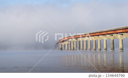 Natchez National Parkway - bridge over Tennessee River from Tennessee to Alabama, foggy November sunrise Natchez National Parkway - bridge over Tennessee River from Tennessee to Alabama, foggy November sunrise 134649790