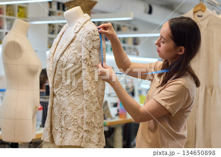 Fashion Design Tailoring a Beautiful Lace Garment on a Dress Form for Perfect Fit Fashion Design Tailoring a Beautiful Lace Garment on a Dress Form for Perfect Fit 134650898