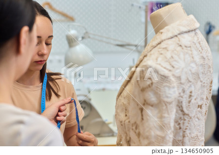 Fashion Design Tailoring a Beautiful Lace Garment on a Dress Form for Perfect Fit Fashion Design Tailoring a Beautiful Lace Garment on a Dress Form for Perfect Fit 134650905