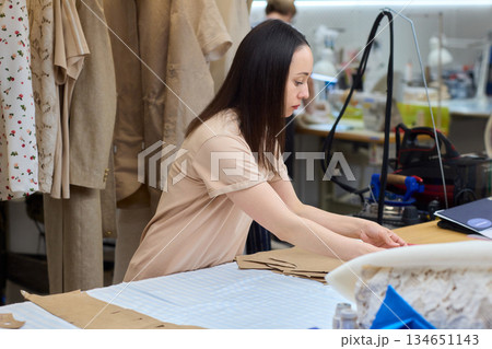 Tailoring Craftsmanship A Fashion Designer at Work Creating Beautiful Patterns with Precision Tailoring Craftsmanship A Fashion Designer at Work Creating Beautiful Patterns with Precision 134651143