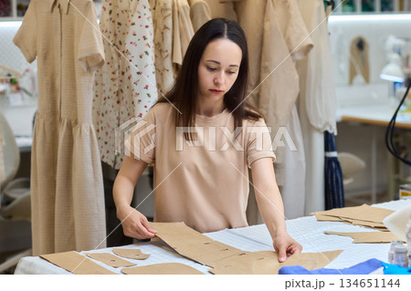 Tailoring Craftsmanship A Fashion Designer at Work Creating Beautiful Patterns with Precision Tailoring Craftsmanship A Fashion Designer at Work Creating Beautiful Patterns with Precision 134651144