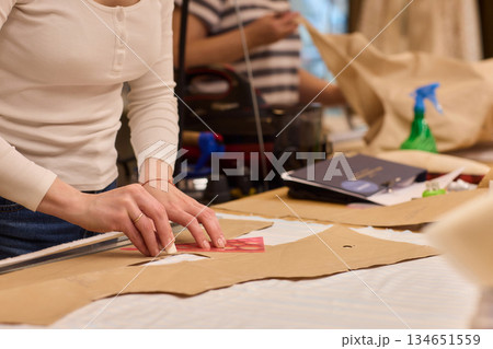 Tailoring Craftsmanship A Fashion Designer at Work Creating Beautiful Patterns with Precision Tailoring Craftsmanship A Fashion Designer at Work Creating Beautiful Patterns with Precision 134651559