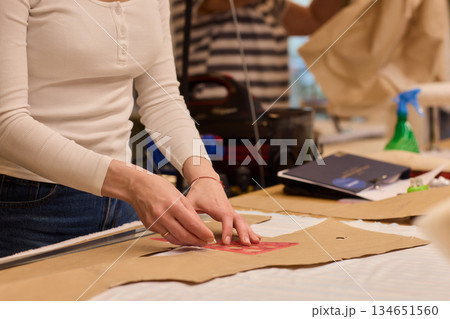 Tailoring Craftsmanship A Fashion Designer at Work Creating Beautiful Patterns with Precision Tailoring Craftsmanship A Fashion Designer at Work Creating Beautiful Patterns with Precision 134651560