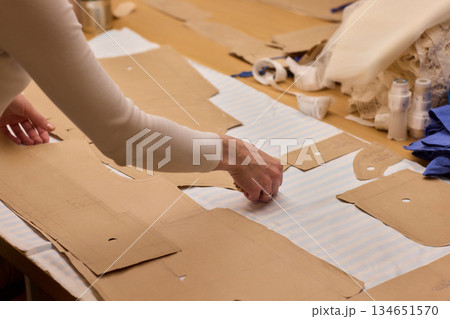 Tailoring Craftsmanship A Fashion Designer at Work Creating Beautiful Patterns with Precision Tailoring Craftsmanship A Fashion Designer at Work Creating Beautiful Patterns with Precision 134651570
