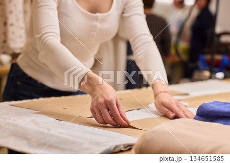 Tailoring Craftsmanship A Fashion Designer at Work Creating Beautiful Patterns with Precision Tailoring Craftsmanship A Fashion Designer at Work Creating Beautiful Patterns with Precision 134651585