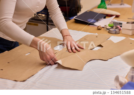 Tailoring Craftsmanship A Fashion Designer at Work Creating Beautiful Patterns with Precision Tailoring Craftsmanship A Fashion Designer at Work Creating Beautiful Patterns with Precision 134651588