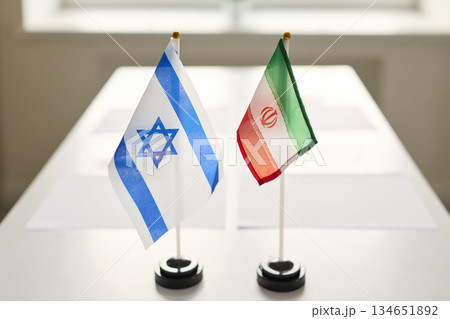 Israel and Iran desk flags at meeting table symbolizing diplomacy and talks 134651892