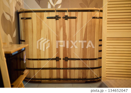 Cozy sauna setting, Wooden sauna with soothing ambiance, Serene cedar sauna with gentle steam haze, Relaxing timber cabin sauna featuring warm lighting and calming 134652047