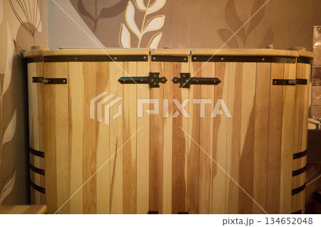 Cozy sauna setting, Wooden sauna with soothing ambiance, Serene cedar sauna with gentle steam haze, Relaxing timber cabin sauna featuring warm lighting and calming 134652048