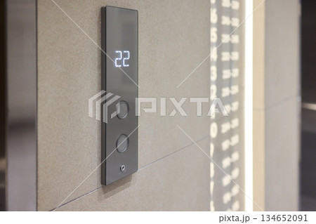 High-tech elevator panel featuring tactile buttons and illuminated screen, Advanced elevator interface showcasing touch sensitive controls alongside bright digital display screen 134652091